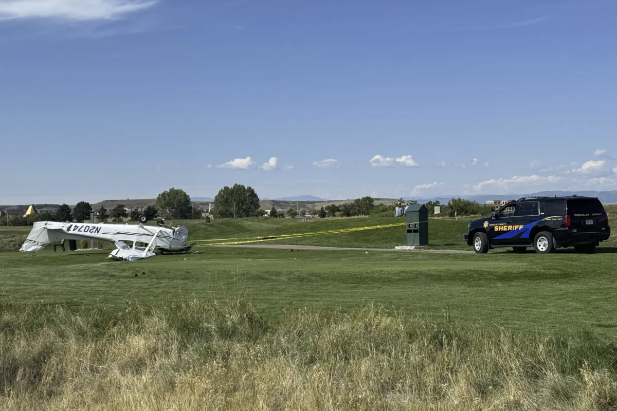 This photo provided by the Douglas County, Colo., Sheriff's Office shows a small plane, left, that crashed and landed upside down on a Denver-area golf course Wednesday, Sept. 11, 2024. (Douglas County Sheriff's Office via AP)