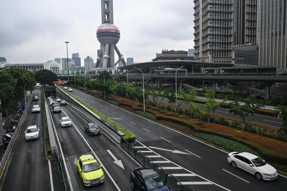 Motorists commute on a street in the Lujiazui financial district in Shanghai on June 5, 2024. (Hector Retamal/AFP via Getty Images)