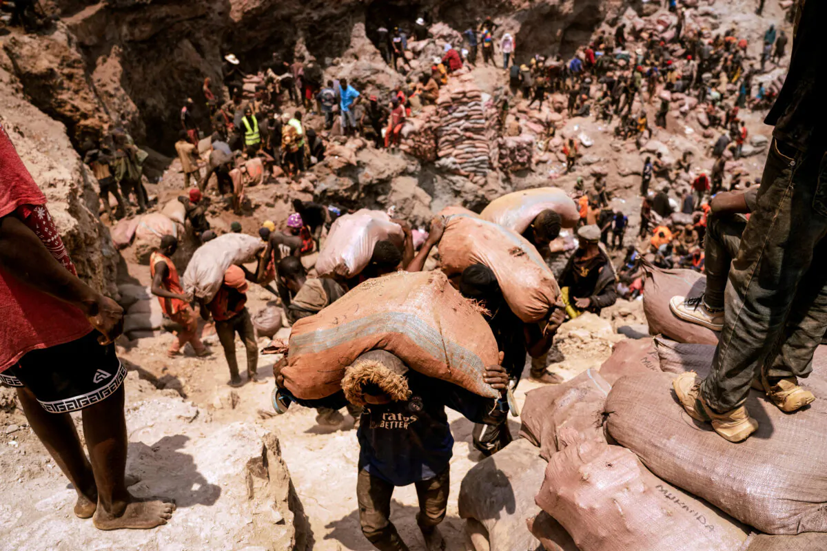 Artisanal miners carry sacks of ore at the Shabara artisanal mine near Kolwezi, Democratic Republic of the Congo, on Oct. 12, 2022. (Junior Kannah/AFP via Getty Images)