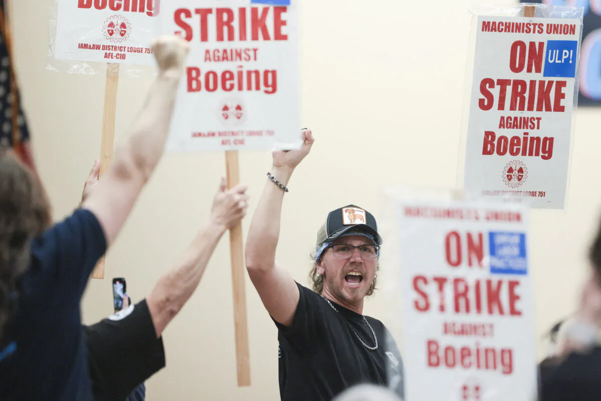 Union members react as Aerospace Machinists District 751 President Jon Holden (out of frame) announces that union members rejected a proposed Boeing contract and will go on strike, following voting results at their union hall in Seattle on Sept. 12, 2024. (Jason Redmond/AFP via Getty Images)
