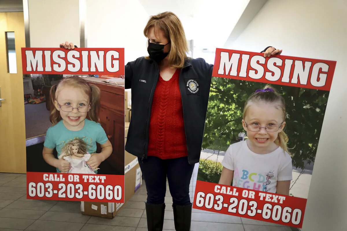 Manchester Police Public Information Officer Heather Hamel holds two reward posters, Jan. 4, 2022, in Manchester, N.H., that show missing girl Harmony Montgomery. (John Tlumacki/The Boston Globe via AP)