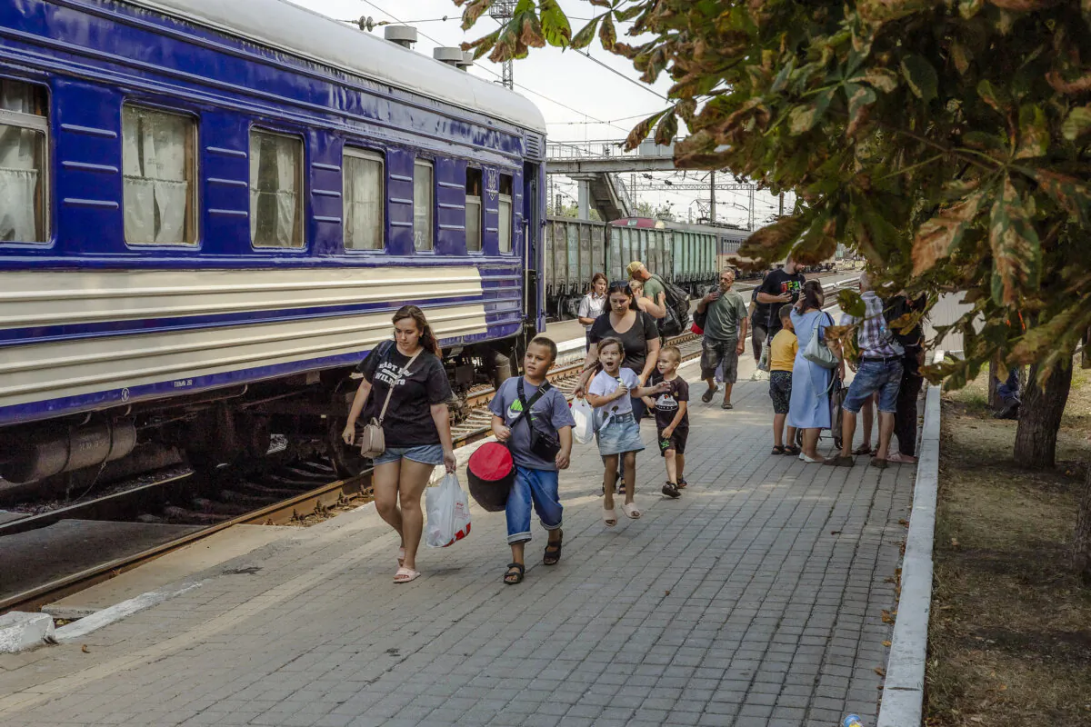 Women with children walk to board an evacuation train in Pokrovsk, in the eastern Donetsk region, on Aug. 2, 2024, amid the Russian invasion of Ukraine. (Roman Pilipey/ AFP via Getty Images)