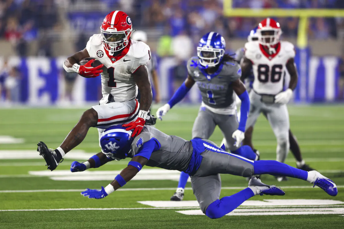 Georgia Bulldogs running back Trevor Etienne (1) jumps over Kentucky Wildcats defensive back Kristian Story (4) during the second half at Kroger Field in Lexington, Ky., on Sep 14, 2024. (Carter Skaggs/Imagn Images via Reuters)