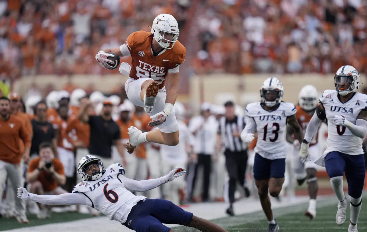 Texas tight end Gunnar Helm (85) leaps over UTSA safety Elliott Davison (6) during the first half of an NCAA college football game in Austin, Texas, on Sept. 14, 2024. (Eric Gay/AP Photo)