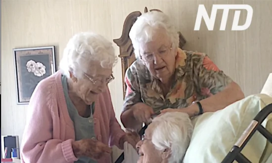 Grandmother Gets Hair Brushed by Sisters