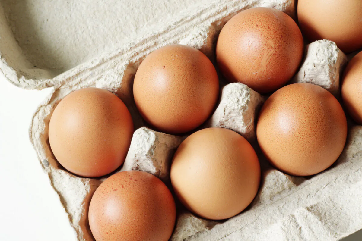 Storing eggs with the pointy end down helps keep the yolk centered and the air cell at the top, which improves freshness over time. (Jurjanephoto/Shutterstock)