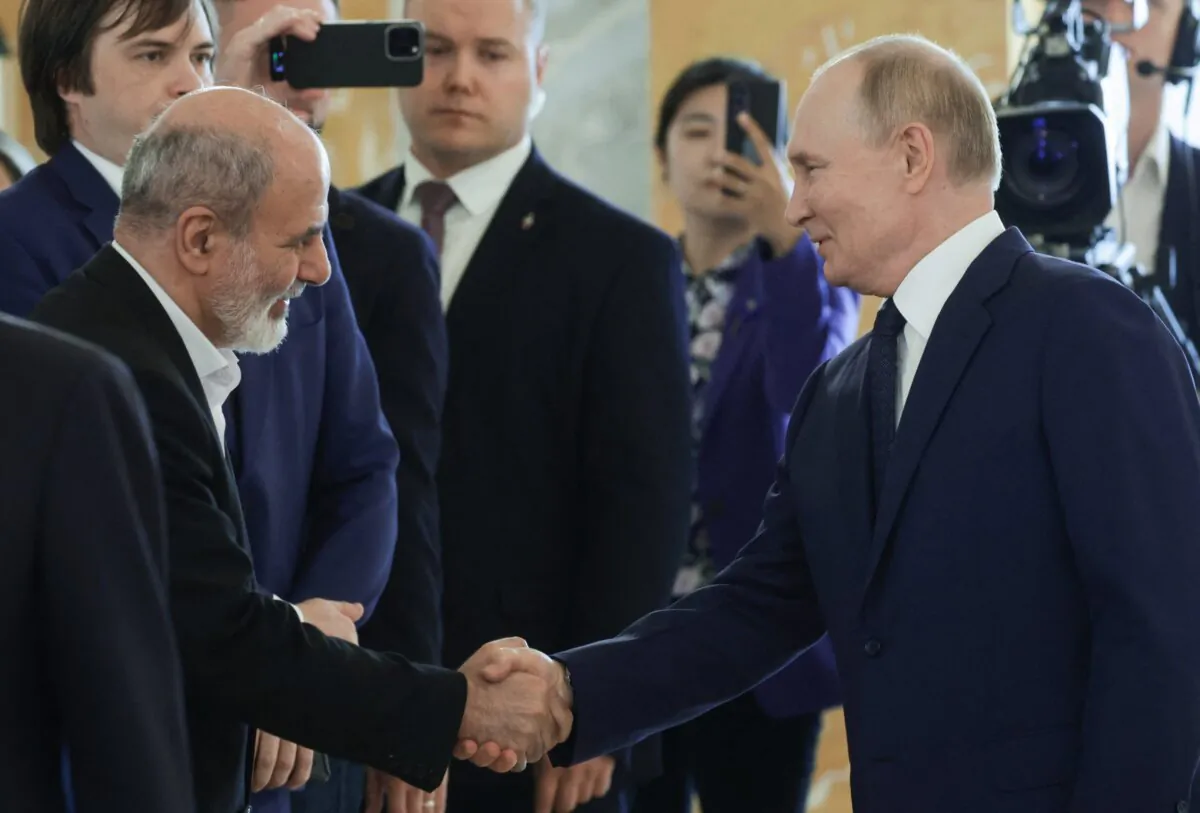 In this pool photograph distributed by the Russian state agency Sputnik, Russian President Vladimir Putin shakes hands with Ali Akbar Ahmadian, secretary of Iran's Supreme National Security Council, as he meets with BRICS high-ranking officials responsible for security matters / national security advisers in Saint Petersburg on Sept. 12, 2024. (Vyacheslav Prokofyev/Pool/AFP via Getty Images)