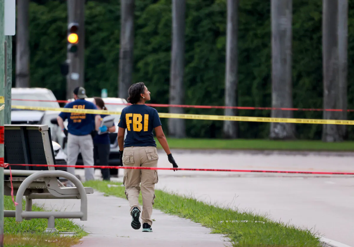 Law enforcement personnel investigate the area around Trump International Golf Club after an apparent assassination attempt of former President Donald Trump in West Palm Beach, Fla., on Sept. 15, 2024. (Joe Raedle/Getty Images)