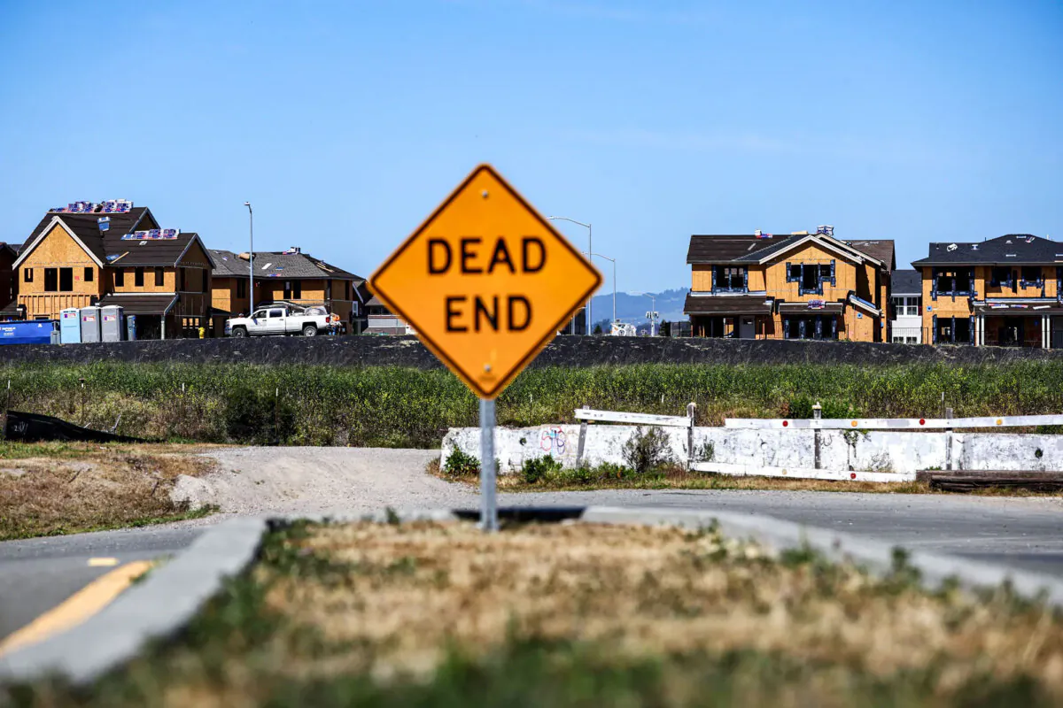 Construction workers work on a home at a housing development in Novato, Calif., on March 23, 2022. (Justin Sullivan/Getty Images)