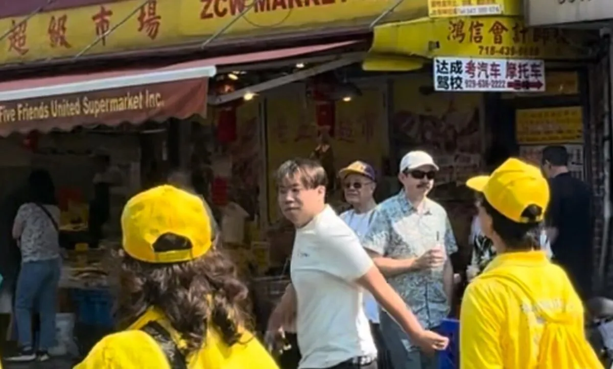 A man (C) allegedly attacked several Falun Gong practitioners during and after a parade in Brooklyn, New York, on Sept. 14, 2024. (Courtesy of Tuidang Center)