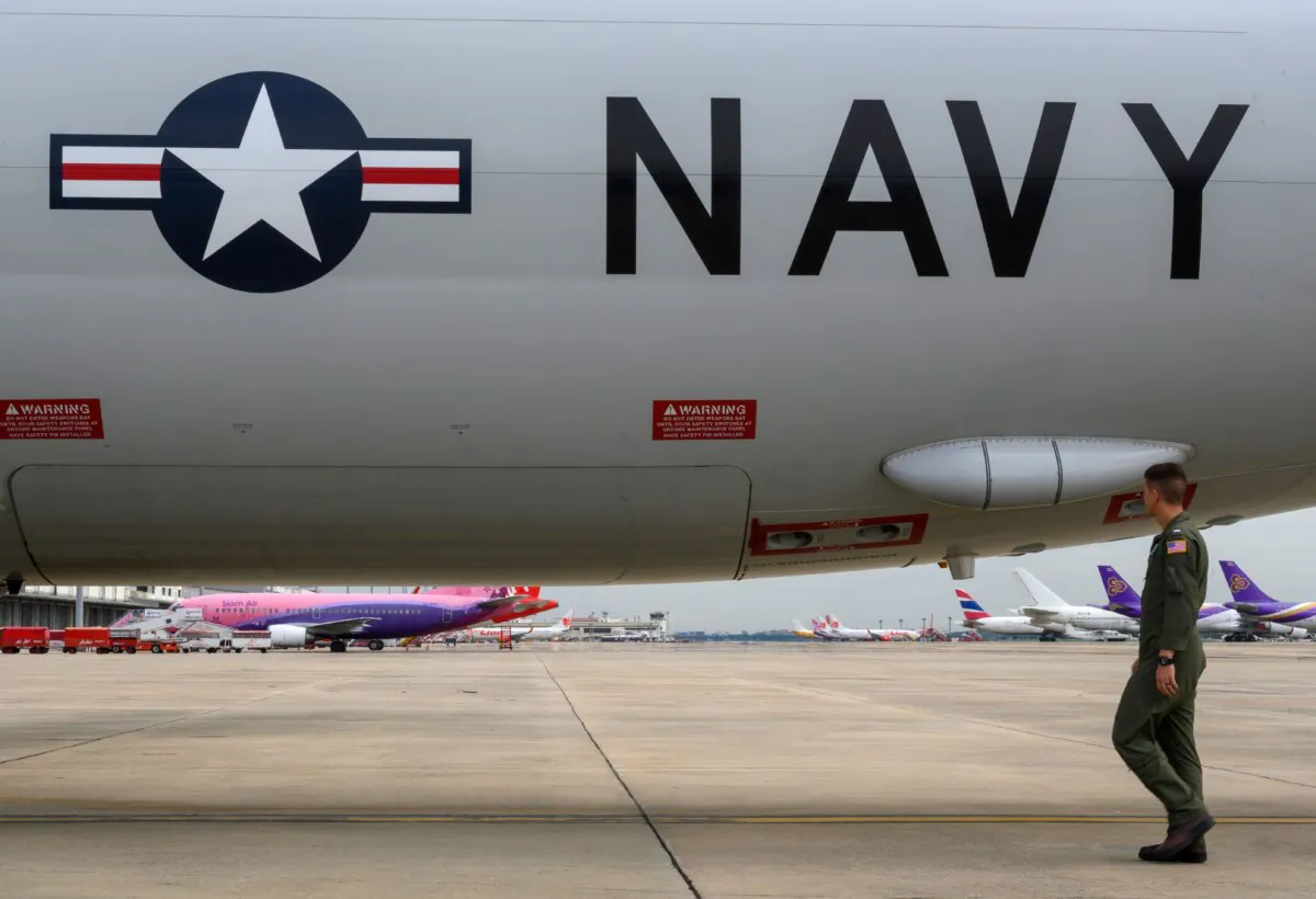 A U.S. Navy aircrew member does a pre-flight walkaround for the P-8A Poseidon maritime patrol and reconnaissance aircraft during the US and Association of Southeast Asian Nations maritime exercise in the Gulf of Thailand on Sept. 5, 2019. (Mladen Antonov/AFP via Getty Images)