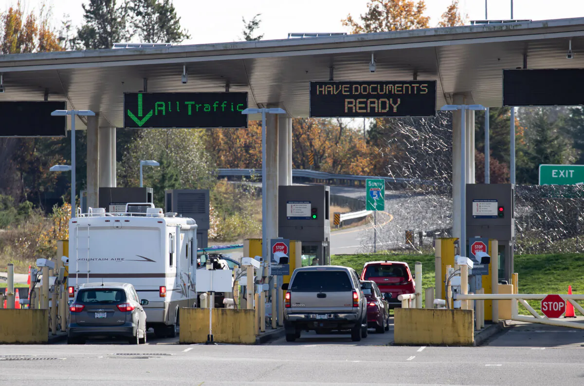 Motorists wait at U.S. Customs and Border Protection inspection booths at the Peace Arch border crossing in Blaine, Wash., across the Canada-U.S. border from Surrey, B.C., on Nov. 8, 2021. (The Canadian Press/Darryl Dyck)