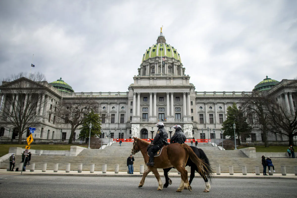 Police officers on horseback patrol in front of the Pennsylvania Capitol Building in Harrisburg, Pa., on Jan. 17, 2021. (Mark Makela/Getty Images)