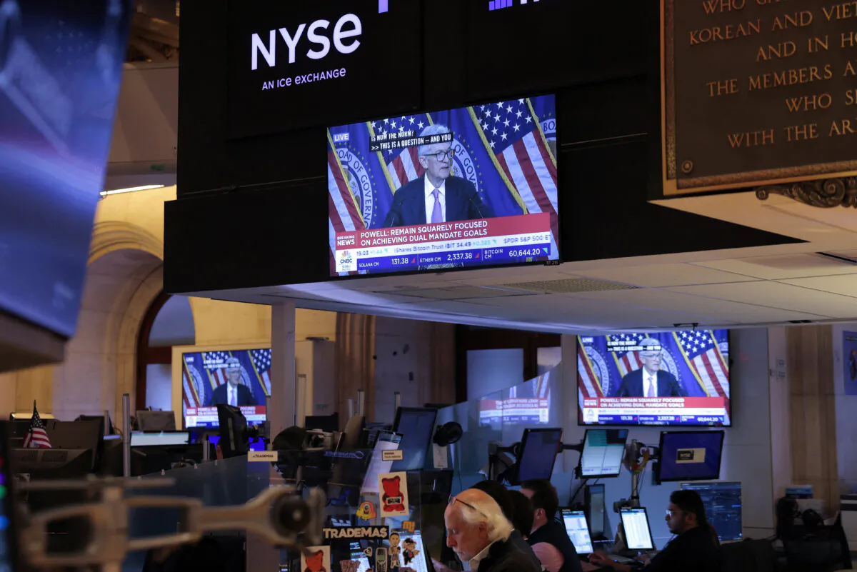 A screen on the trading floor at the New York Stock Exchange (NYSE) display a news conference with Federal Reserve Chair Jerome Powell following the Federal Reserve rate announcement, in New York on Sept. 18, 2024. (Andrew Kelly/Reuters)