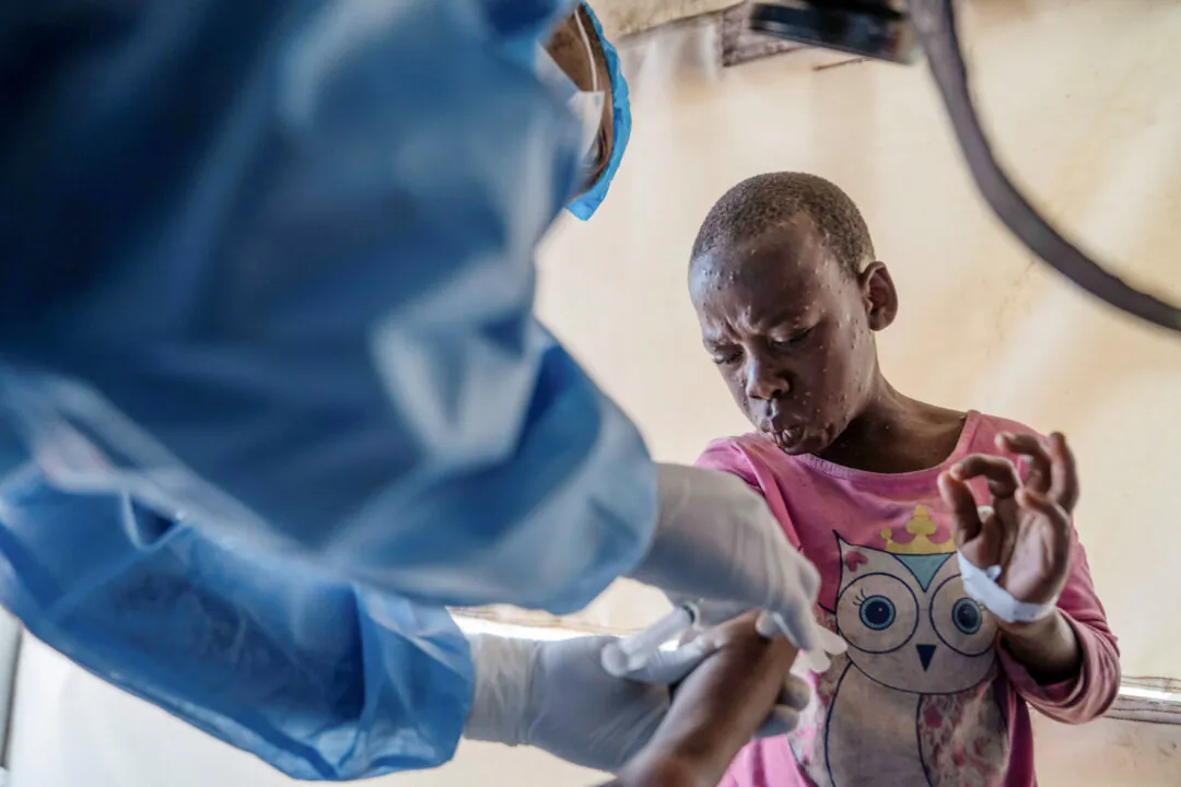A health worker attends to an mpox patient at a treatment center in Munigi, eastern Congo, on Aug. 19, 2024. (Moses Sawasawa/AP Photo)