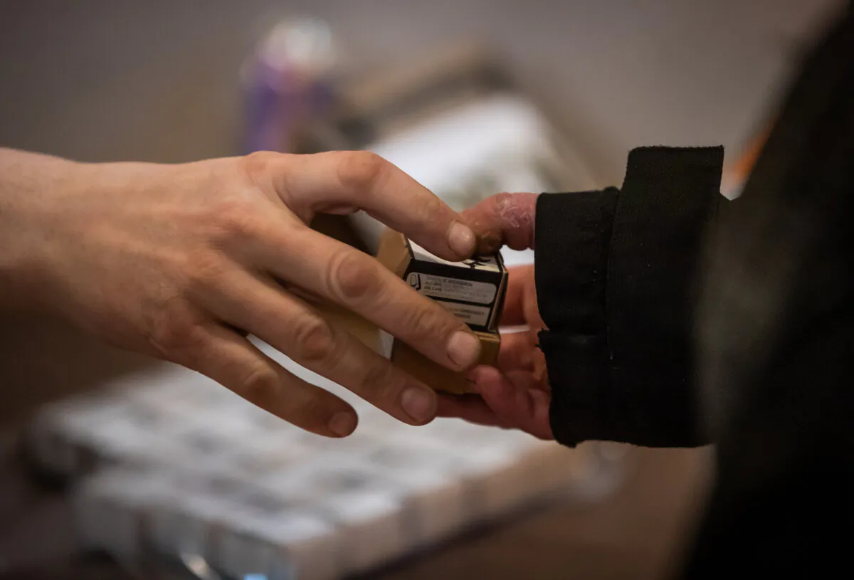 A person receives a tested supply of cocaine after gathering to remember those who died from a suspected illicit drug overdose, in Vancouver, on Feb. 9, 2022. (The Canadian Press/Darryl Dyck)