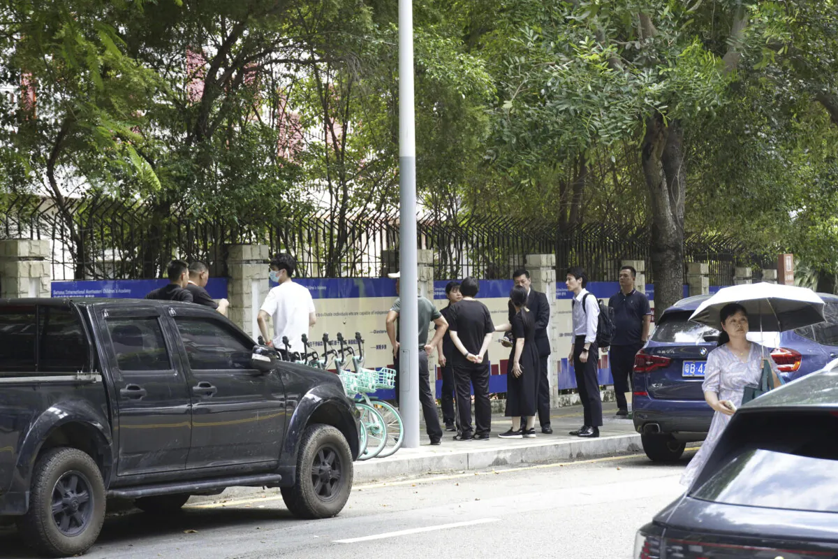 Chinese authorities inspect the scene of a stabbing at the Shenzhen Japanese School in Shenzhen, China, on Sept. 18, 2024. (Kyodo News via AP)