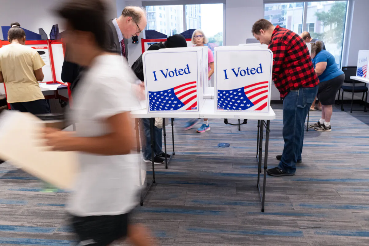 Voters work on their ballots at a polling station at the Elena Bozeman Government Center in Arlington, Va., on Sept. 20, 2024. (AFP via Getty Images)