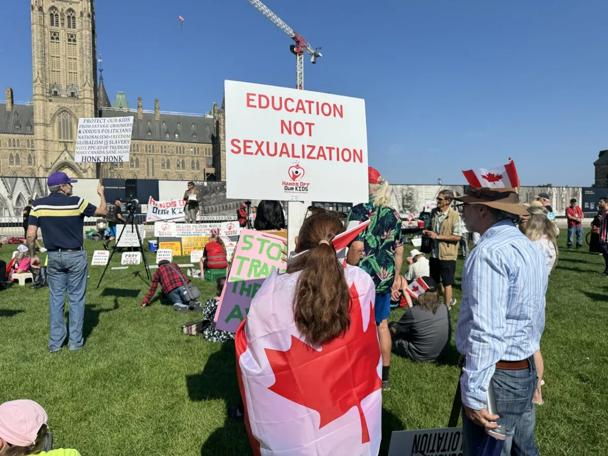 An attendee of the "1 Million March for Children" parental rights rally in Ottawa on Sept. 20, 2024, holds a sign reading "Education Not Sexualization." (Annie Wu/NTD)