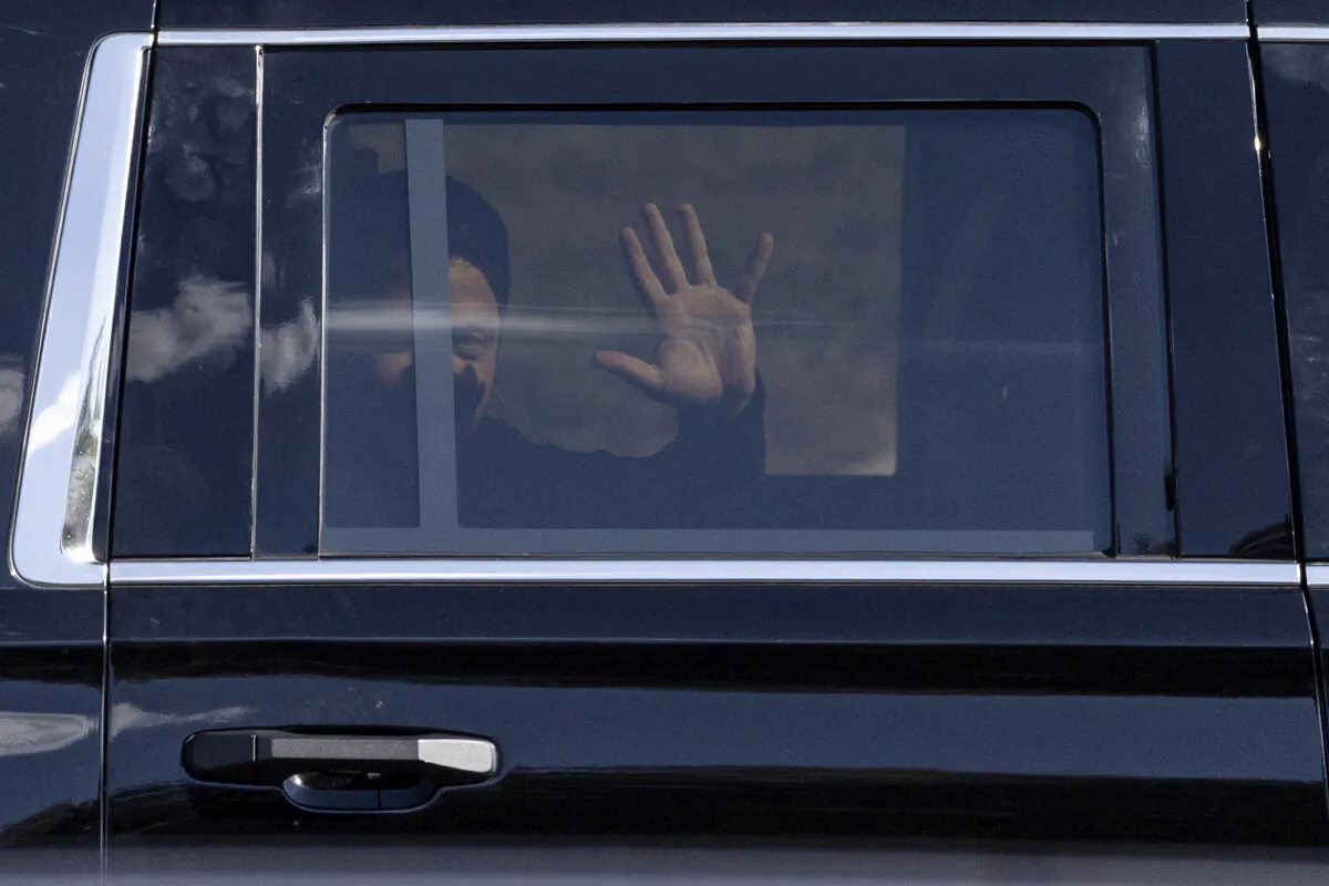 Ukrainian President Volodymyr Zelenskyy waves from the back seat of a U.S. Secret Service vehicle as his motorcade departs the Wilkes-Barre/Scranton International Airport in Pittston Township, Pa., en route to the Scranton Army Ammunition Plant in Scranton, Pa., on Sept. 22, 2024. (Christopher Dolan/The Times-Tribune via AP)