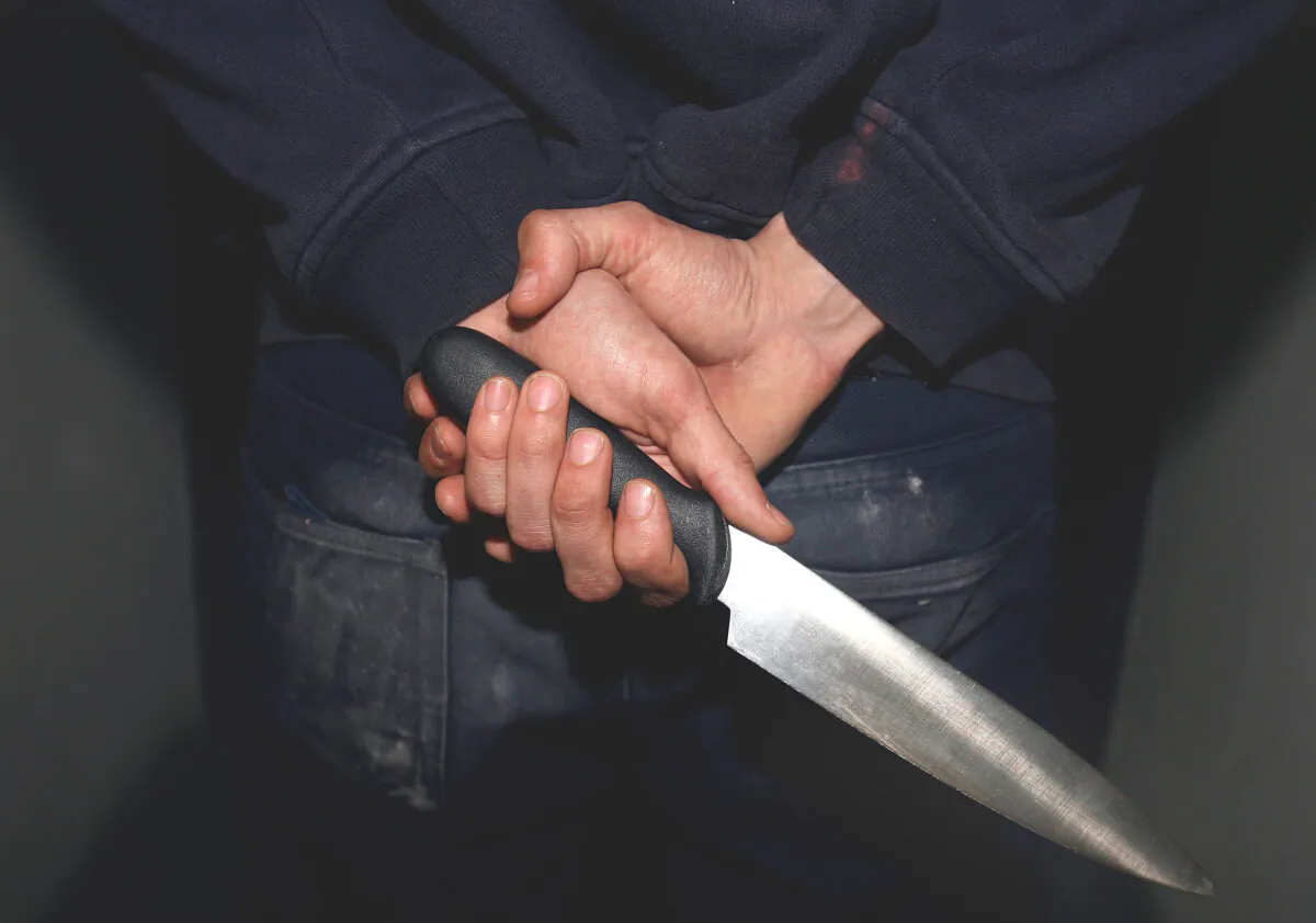 File photo of a man in a hoodie holding a knife on April 25, 2009. (Katie Collins/PA)