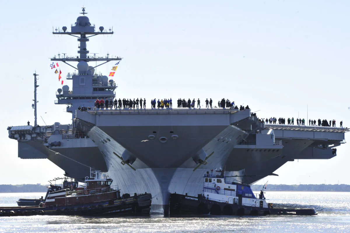 Sailors aboard the aircraft carrier Pre-Commissioning Unit (PCU) Gerald R. Ford (CVN 78) man the rails as the ship departs Huntington Ingalls Industries Newport News Shipbuilding for builder's sea trials off the U.S. East Coast, in Newport News, Va., on April 8, 2017. (Chief Mass Communication Specialist Christopher Delano/U.S. Navy via Getty Images)