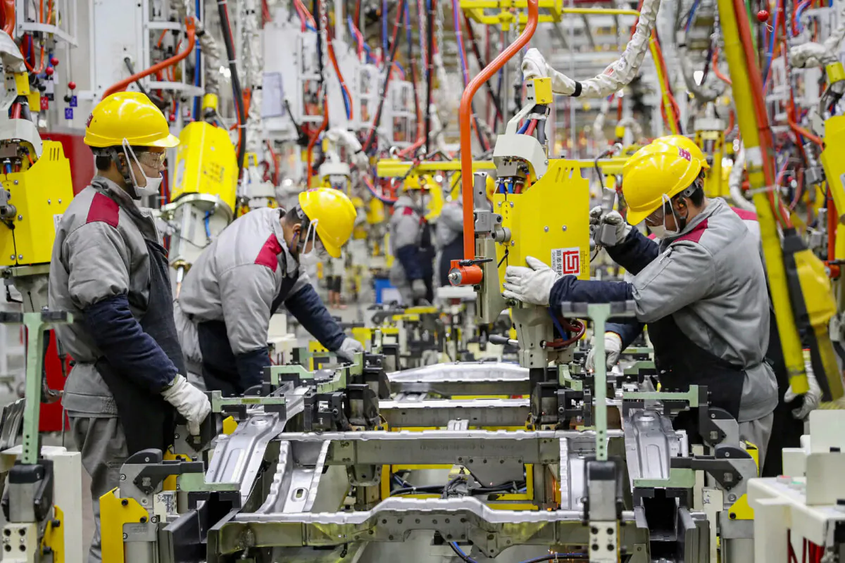 Employees working on a car assembly line at a Beijing Automotive factory in Qingdao, in China's eastern Shandong Province on Jan. 14, 2023. (STR/AFP via Getty Images)