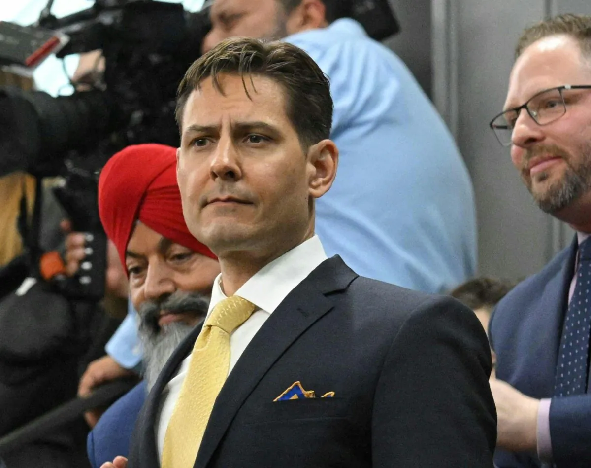Michael Kovrig stands as he and Michael Spavor are recognized before an address by U.S. President Joe Biden in the House of Commons on Parliament Hill in Ottawa on March 24, 2023. (Mandel Ngan/POOL/AFP via Getty Images)