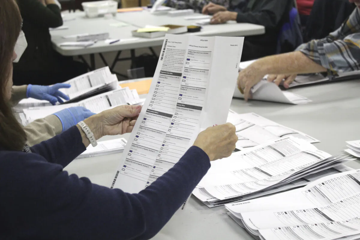 An election worker examines a ballot at the Clackamas County Elections office in Oregon City, Ore., on May 19, 2022. (Gillian Flaccus/AP Photo)
