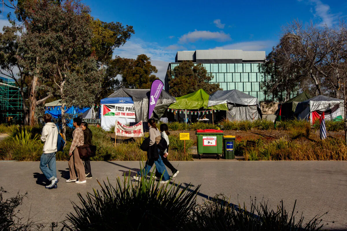 People walk past a Gaza solidarity encampment inside the Australian National University in Canberra, Australia, on June 14, 2024. (George Calvelo/Getty Images)
