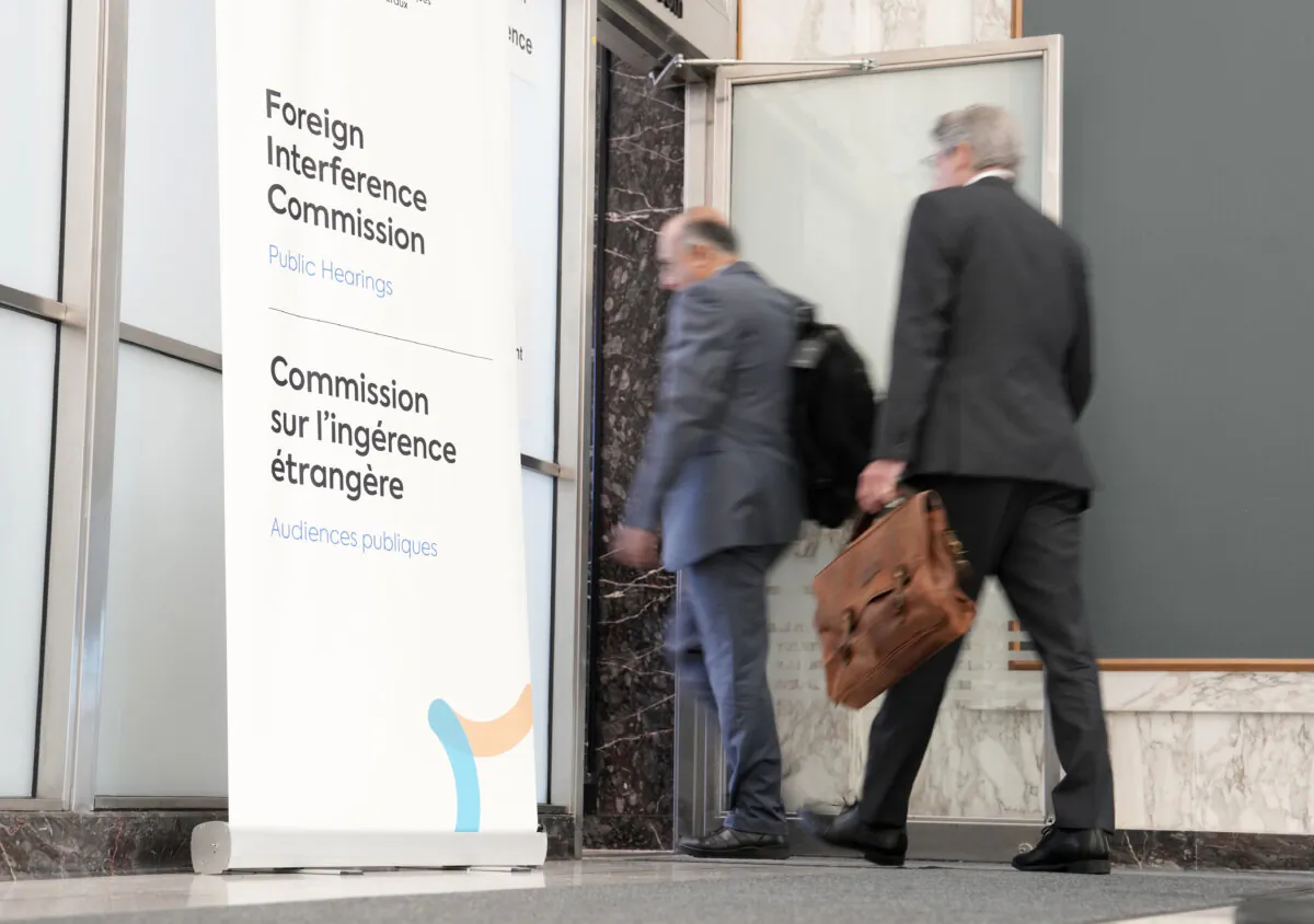 Lawyers enter the hearing room as the Public Inquiry into Foreign Election Interference resumes in Ottawa, on Sept. 16, 2024. (The Canadian Press/Adrian Wyld)