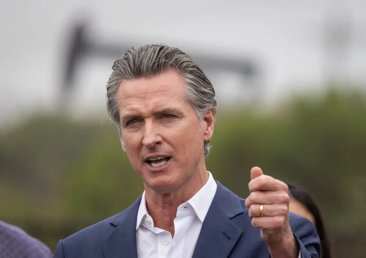 California Gov. Gavin Newsom speaks with oil pumps in the background in Los Angeles on Sep. 25, 2024. (John Fredricks/The Epoch Times)