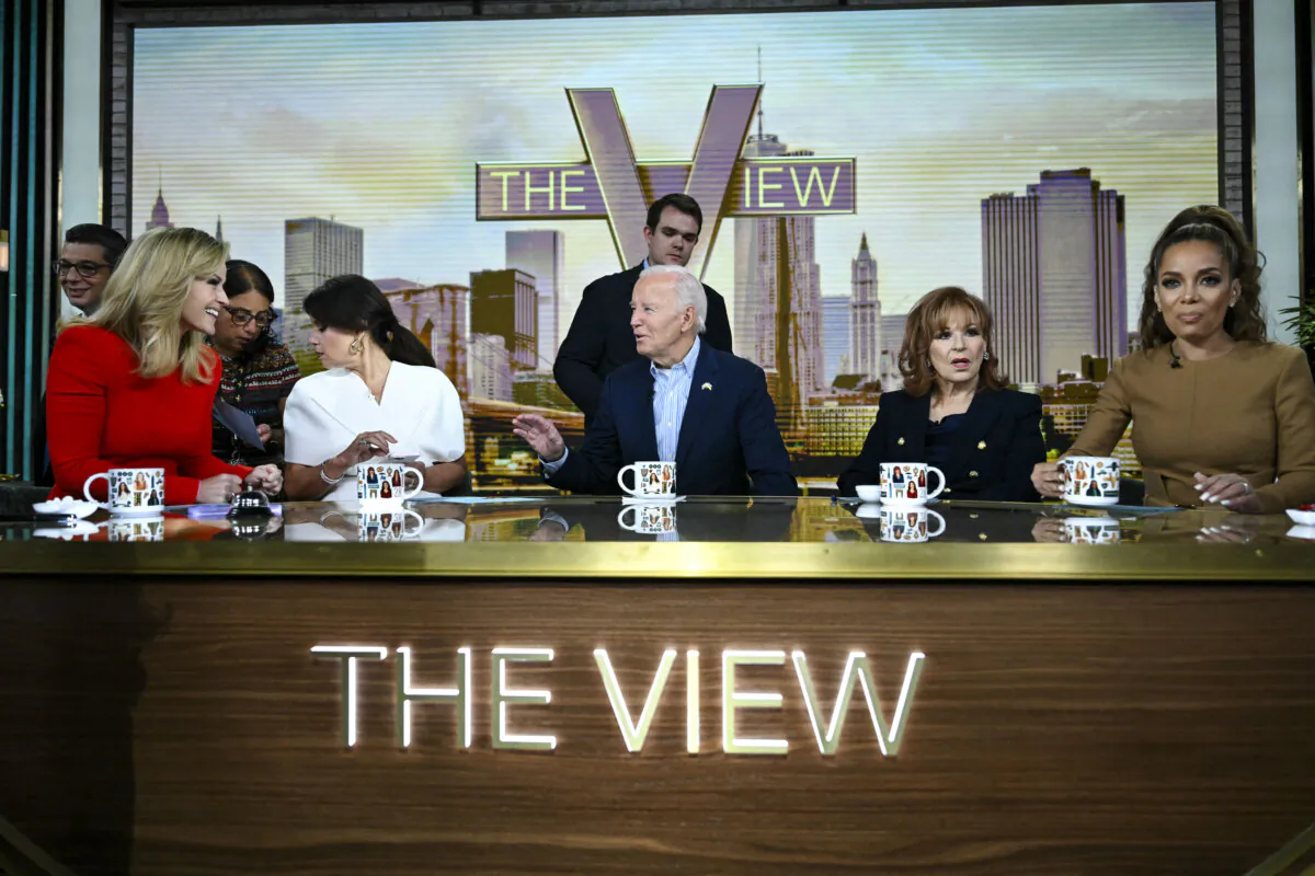 President Joe Biden (C)  speaks to host Sara Haines (L) during a commercial break in live interview on ABC's "The View" in New York City on Sept. 25, 2024. The other hosts (L–R) pictured are Ana Navarro, Joy Behar, and Sunny Hostin. (Andrew Caballero-Reynolds/AFP via Getty Images)