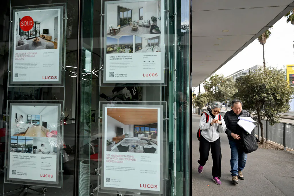 A couple walks past a real estate agents display in Melbourne, Australia on Aug. 6, 2024 (William West/AFP via Getty Images)