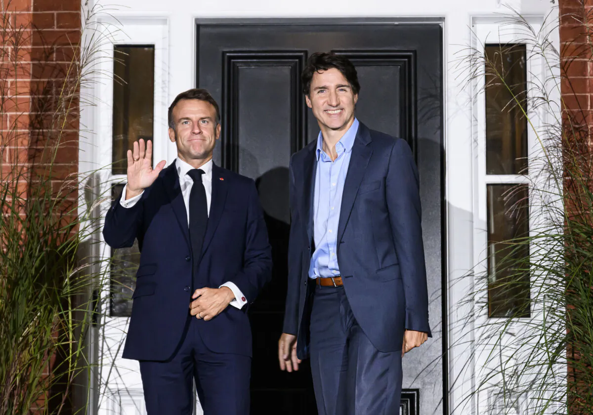Prime Minister Justin Trudeau (R) greets French President Emmanuel Macron outside Rideau Cottage at Rideau Hall, as Macron arrives in Ottawa for a visit to Canada, on Sept. 25, 2024. (The Canadian Press/Justin Tang)
