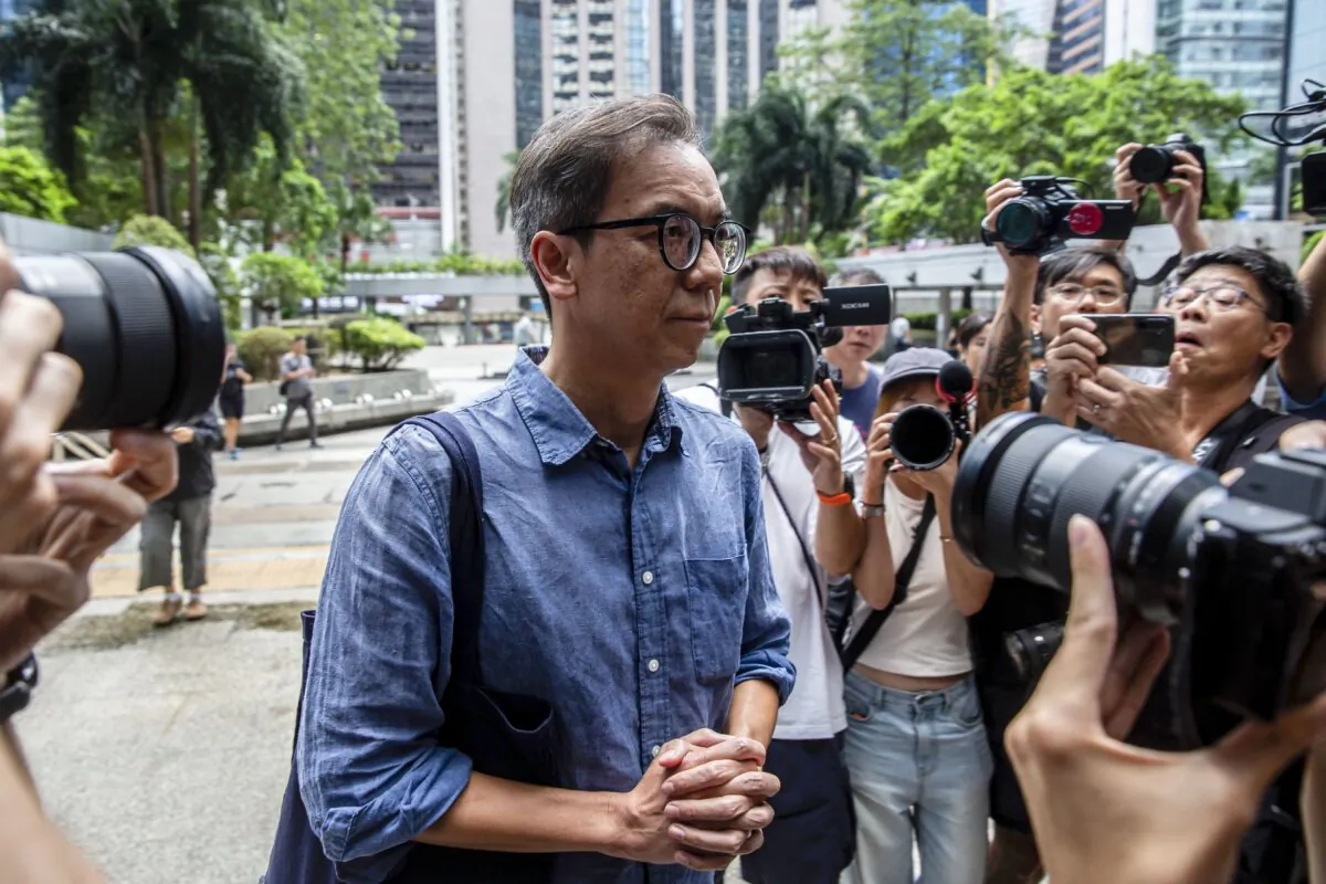 Chung Pui-kuen (C), the former chief editor of Hong Kong's now shuttered pro-democracy news outlet Stand News, arrives at the district court in Hong Kong on Sept. 26, 2024. (Isaac Lawrence/AFP via Getty Images)