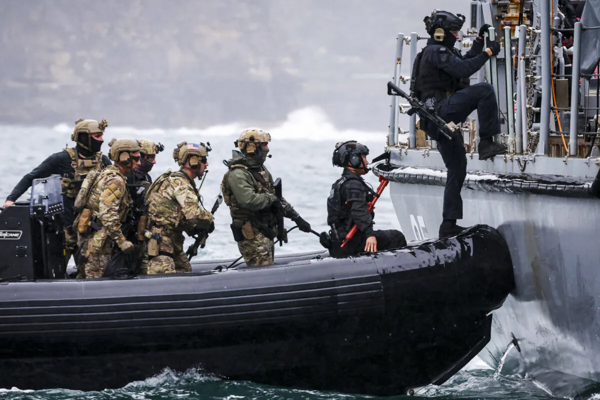 Personnel from the Defence Forces of Australia, Japan, South Korea and the United States, plus officers from the Australian Federal Police and New South Wales Police Force, participate in a boarding exercise as part of training activities for Exercise Pacific Protector 2024, at Sydney Harbour in Sydney, Australia, on Sept. 26, 2024. (DAVID GRAY/AFP via Getty Images)