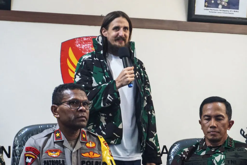 New Zealand pilot Phillip Mehrtens (C), who was snatched by rebels in Indonesia's restive region of Papua in February last year, speaks during a press conference following his release in Timika, Central Papua on September 21, 2024. New Zealand pilot Phillip Mehrtens has been released from captivity by rebels in Indonesia's restive region of Papua and was in good health despite the 19-month-long ordeal, Indonesian and New Zealand authorities said on Sept. 21. (Endy Langobelen/AFP via Getty Images)