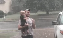 Baby Plays in Summer Rain With Father