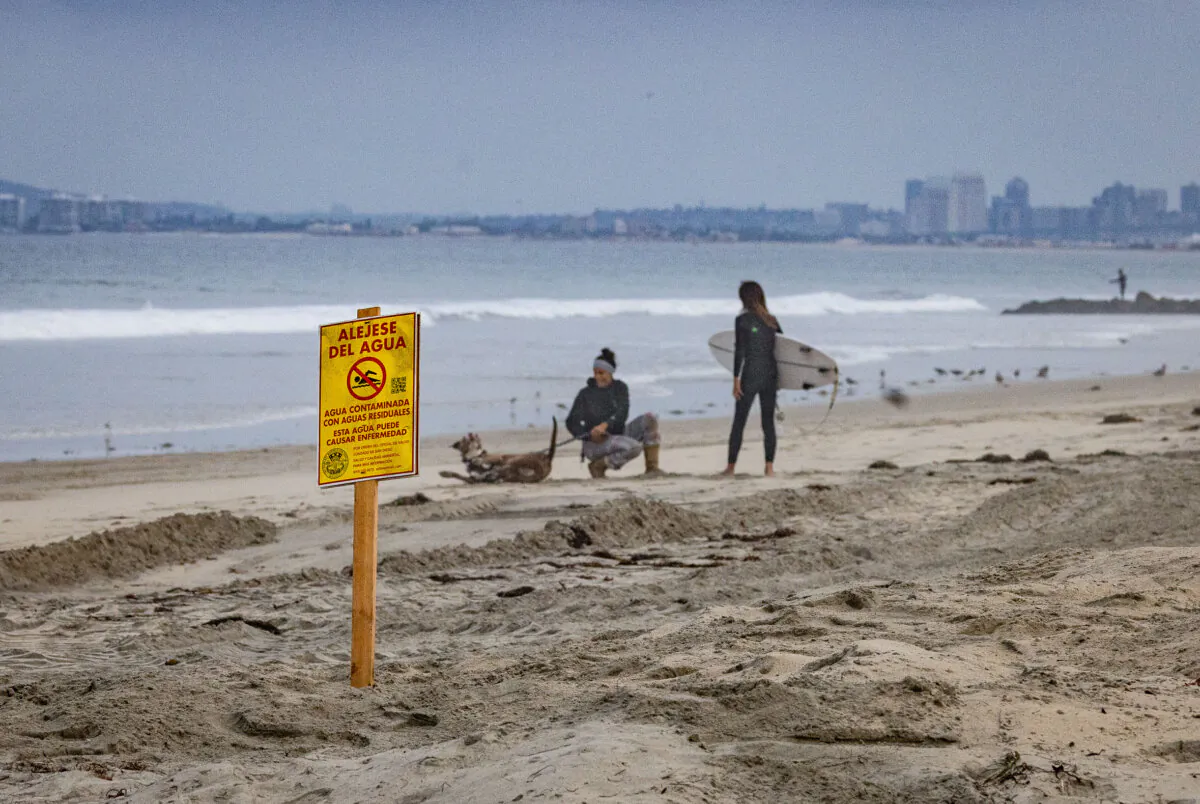 Water advisory signs line the sand of Imperial Beach, Calif., on Sept. 19, 2024. (John Fredricks/The Epoch Times)