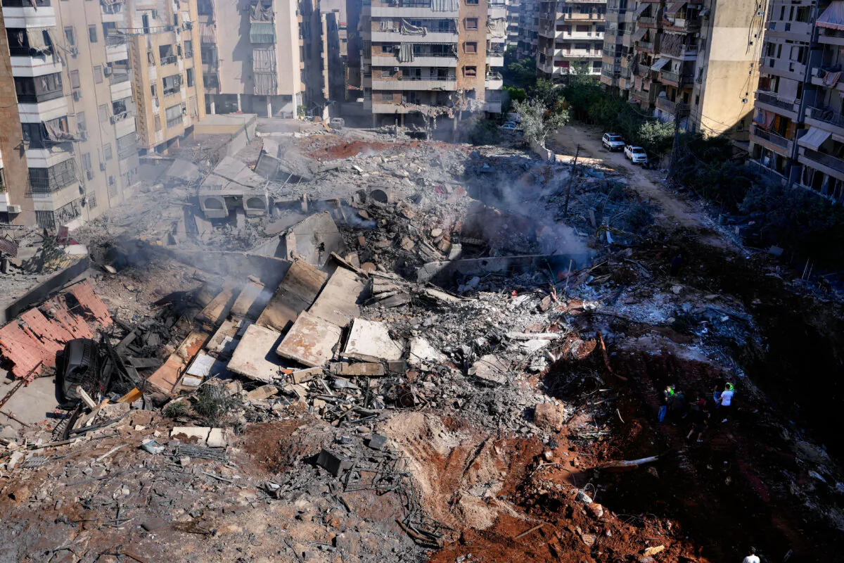 People gather near the site of the killing of Hezbollah leader Hassan Nasrallah in Beirut's southern suburbs, Lebanon, on Sept. 29, 2024. (Hassan Ammar/AP Photo)