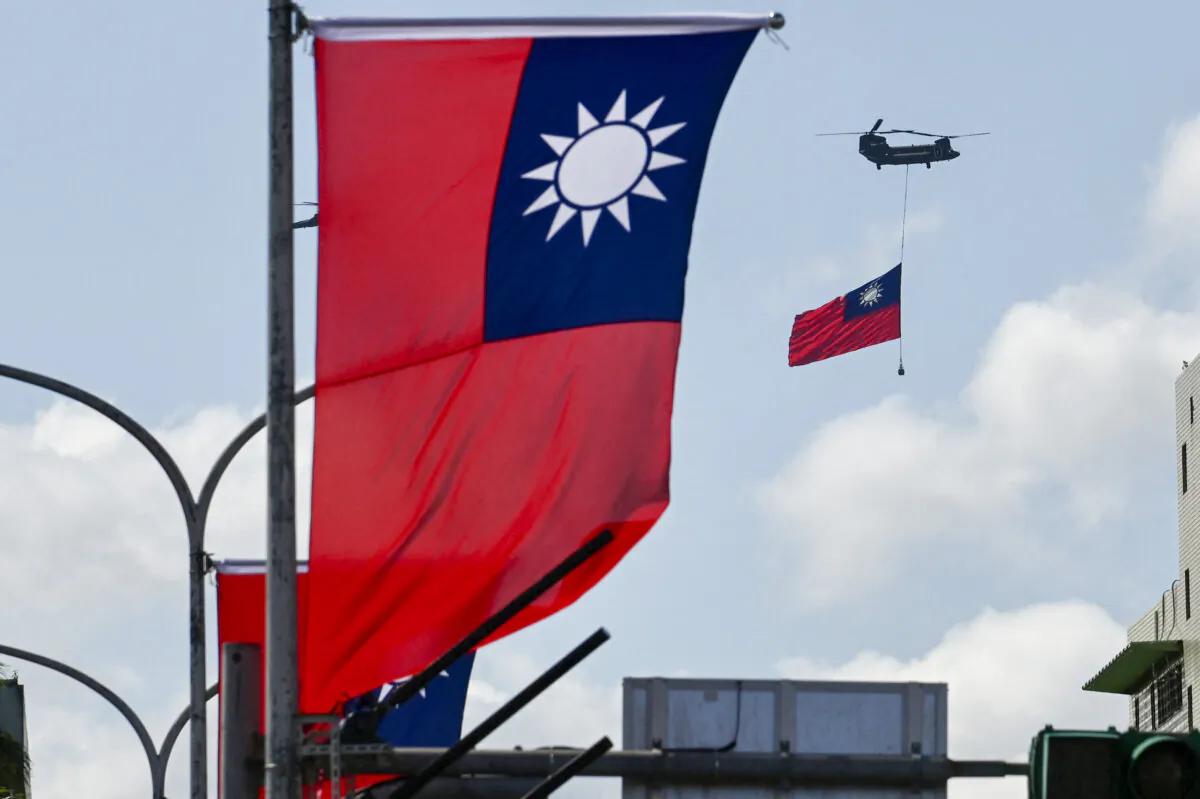 A CH-47 Chinook helicopter carries a Taiwan flag during national day celebrations in Taipei, Taiwan, on Oct. 10, 2021. (Sam Yeh/AFP via Getty Images)