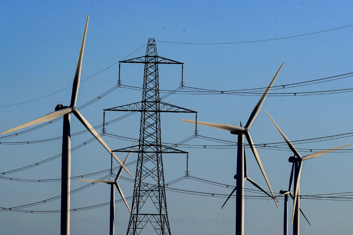 A view of the Little Cheyne Court Wind Farm amongst existing electricity pylons on the Romney Marsh in Kent, England, on Dec. 28, 2017. (Gareth Fuller/PA)