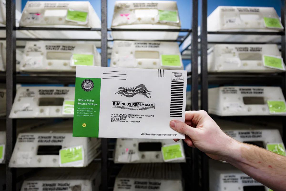 Director of the Board of Elections Tyler Burns holds a test ballot during a mail-in ballot processing demonstration at the Board of Elections office in Doylestown, Pa., on Sep. 30, 2024. (Hannah Beier/Getty Images)
