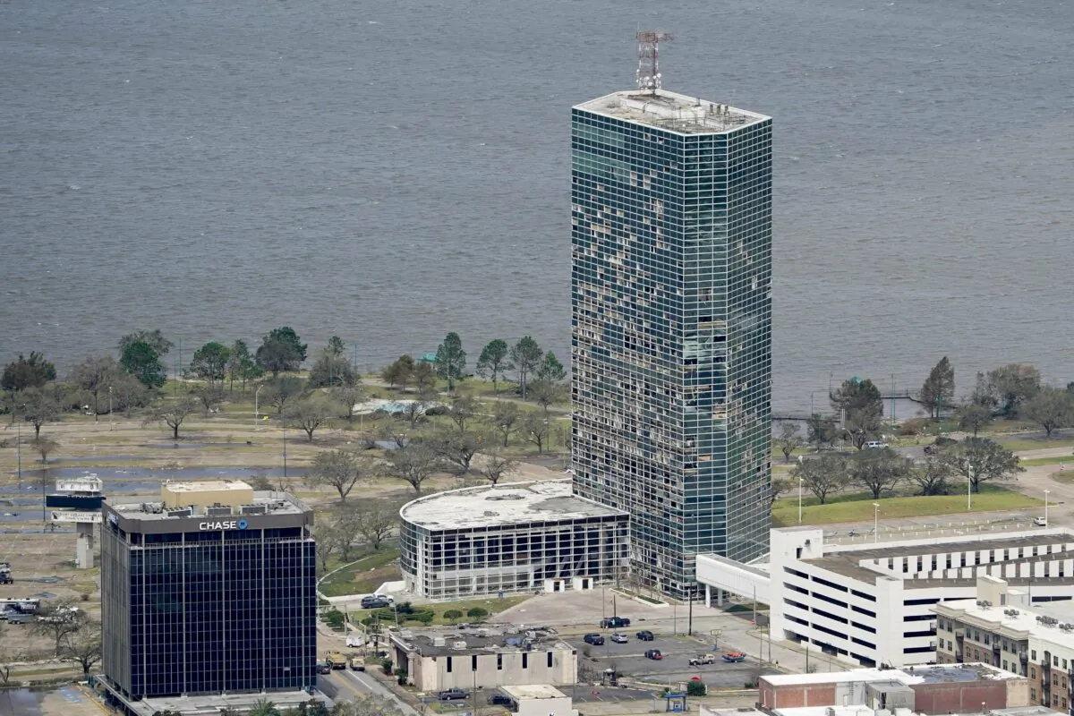 FILE - Debris surrounds damaged buildings, including the Hertz Building, in the aftermath of Hurricane Laura near Lake Charles, La., on Aug. 27, 2020 (David J. Phillip/AP Photo, File)