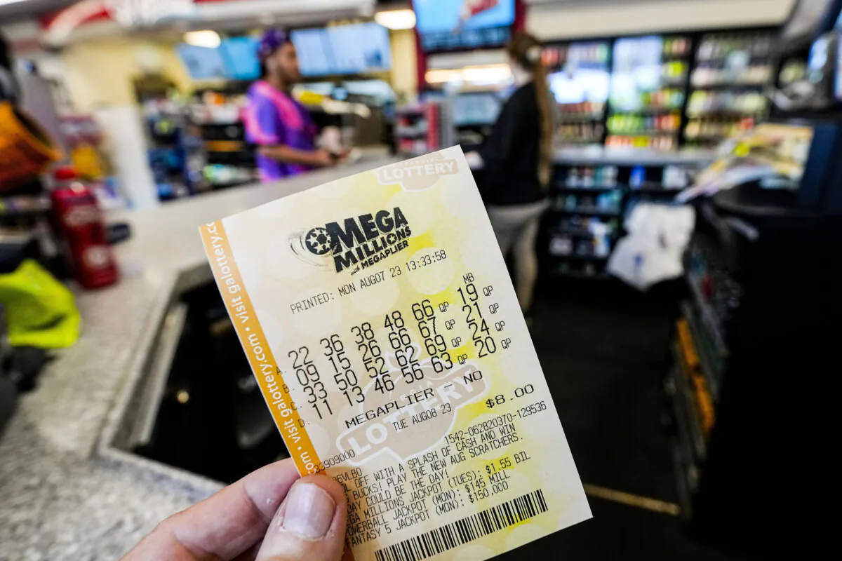 FILE - A Mega Millions ticket is seen as a person makes a purchase inside a convenience store in Kennesaw, Ga., on Aug. 7, 2023. (Mike Stewart/AP Photo, File)