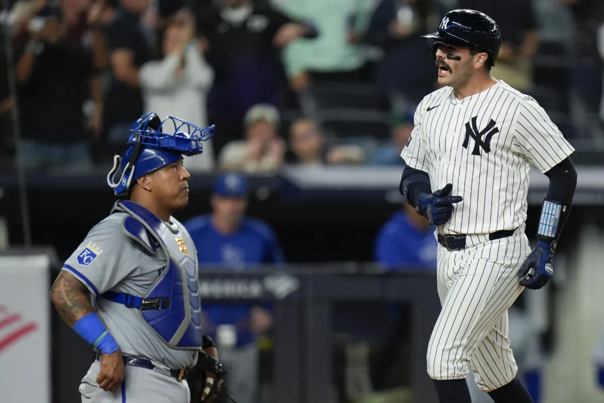 Kansas City Royals catcher Salvador Perez, left, looks on as New York Yankees' Austin Wells, right, crosses home plate after hitting a three-run home run during the seventh inning of a baseball game at Yankee Stadium, in New York, on Sept. 9, 2024. (Seth Wenig/AP Photo)