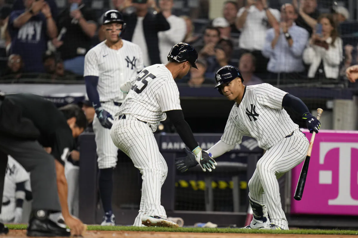 New York Yankees' Gleyber Torres (25), center, celebrates after his home run with Juan Soto, right, during the first inning of a baseball game against the Boston Red Sox at Yankee Stadium, Thursday, Sept. 12, 2024, in New York. (AP Photo/Seth Wenig)