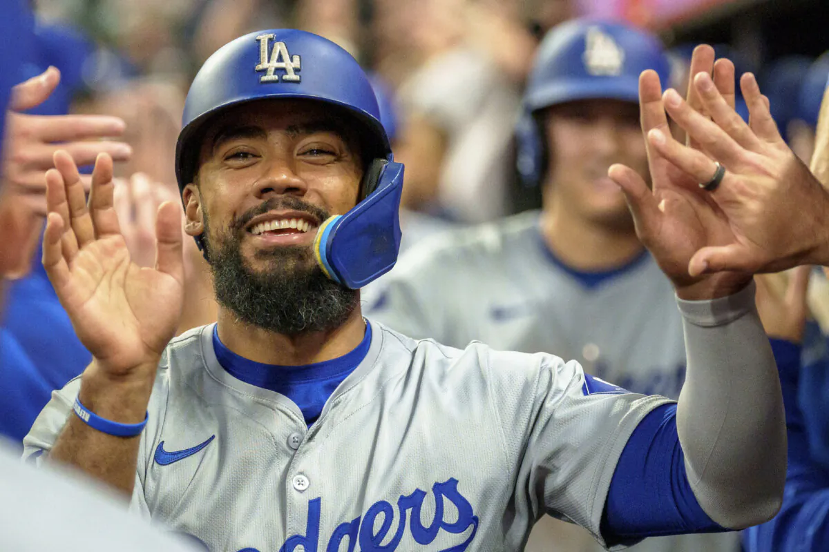 Los Angeles Dodgers' Teoscar Hernández celebrates in the dugout after Freddie Freeman hit a three-run home run in the seventh inning of a baseball game against the Atlanta Braves in Atlanta, on Sept. 16, 2024. (Jason Allen/AP Photo)