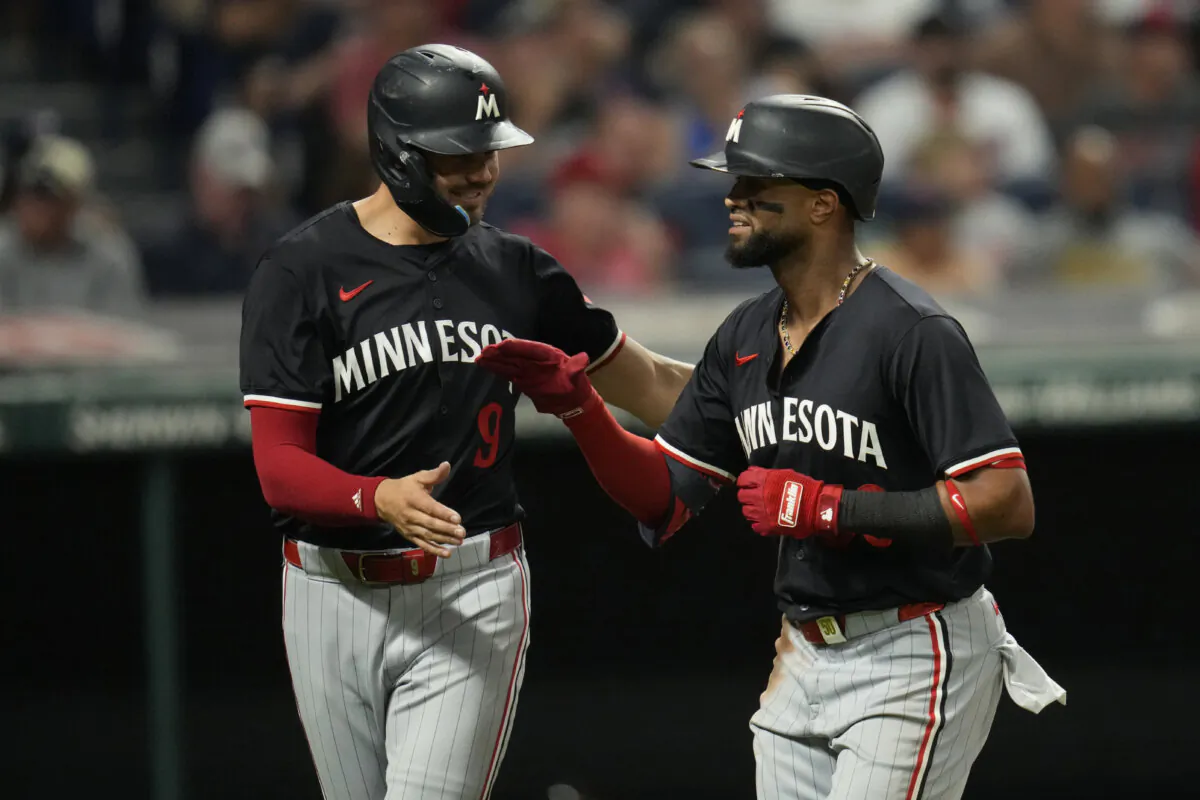 Minnesota Twins' Trevor Larnach, left, congratulates Willi Castro, on his home run in the eighth inning of a baseball game against the Cleveland Guardians in Cleveland, on Sept. 17, 2024. (Sue Ogrocki/AP Photo)